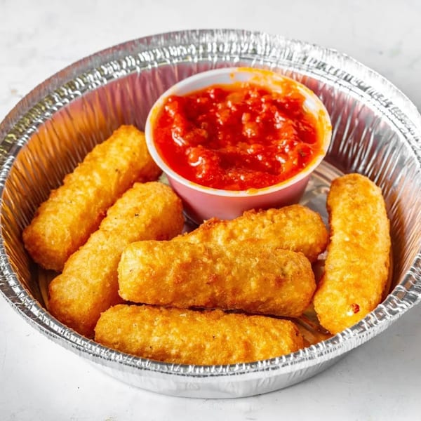 Golden-brown mozzarella sticks and a cup of red marinara sauce in a foil container.